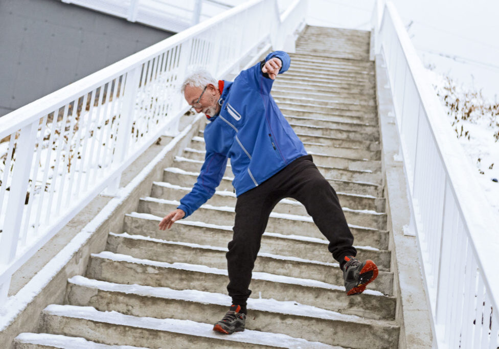 Senior man on a icy staircase