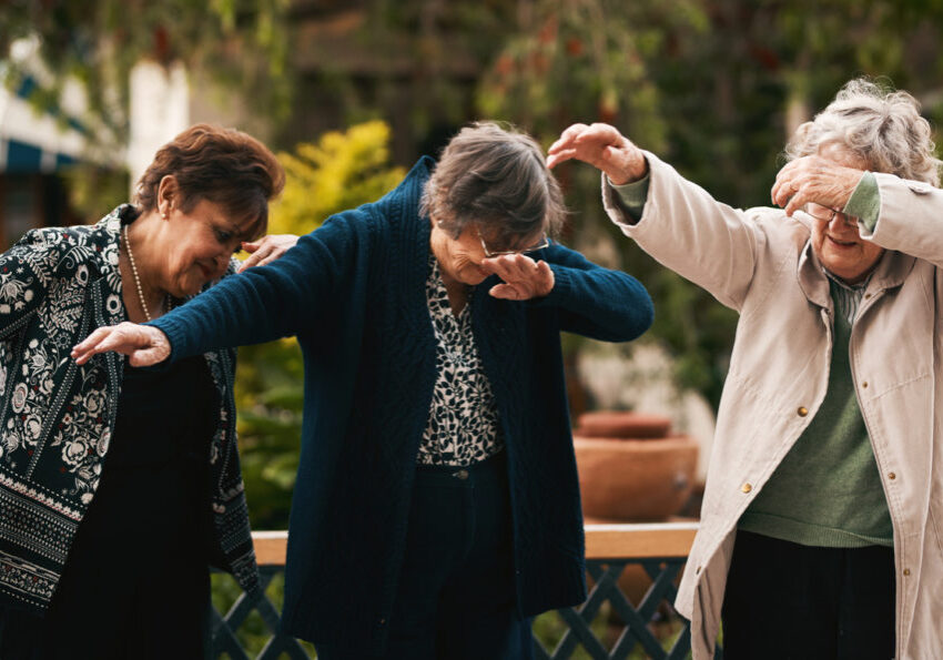 Cropped shot of a group of senior woman standing together and dabbing during a tea party outdoors