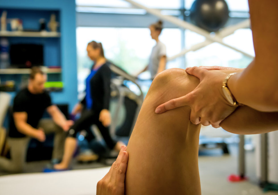 Woman receiving physiotherapy treatment after a knee injury