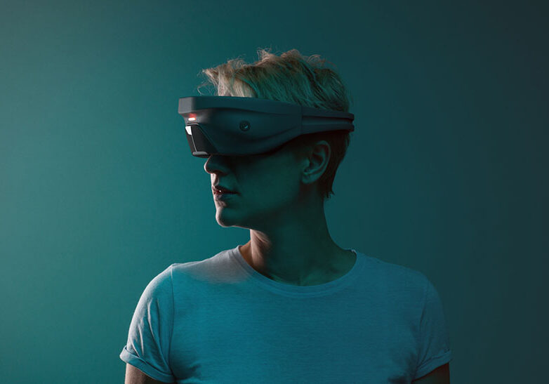 Young woman is using VR device. Studio shot with lot of copy space.